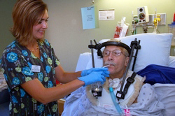 Clinician feeding patient with spinal cord injury