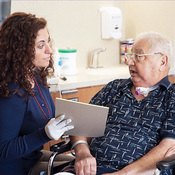 Caregiver explaining to a Passy Muir Valve User 